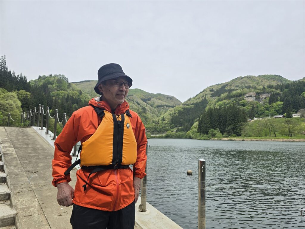 沼沢湖の湖畔でライフジャケットを着たAさん